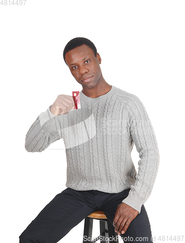 Image of African man holding up his credit card