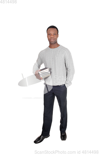 Image of African man standing with books in his hands