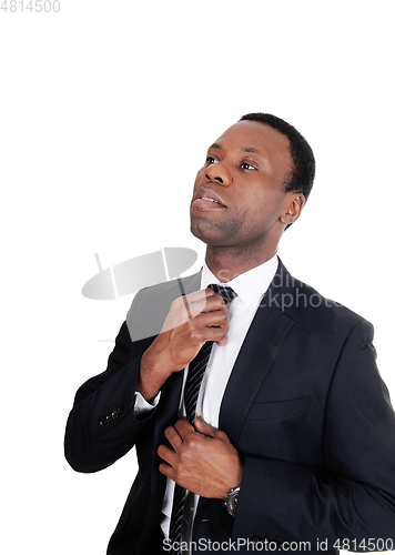 Image of African business man fixing his tie