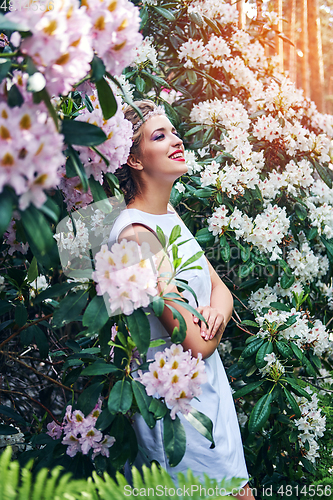 Image of girl in dress in rhododendron garden