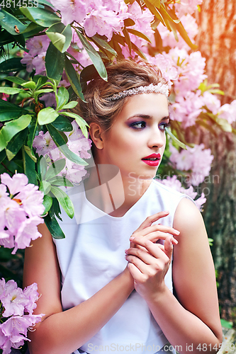 Image of girl in dress in rhododendron garden