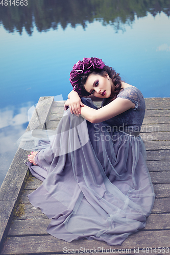 Image of girl in dress in rhododendron garden