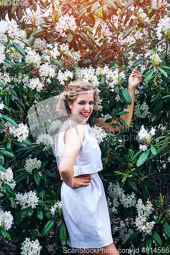 Image of girl in dress in rhododendron garden