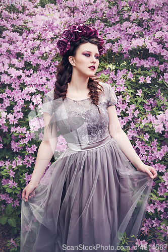 Image of girl in dress in rhododendron garden