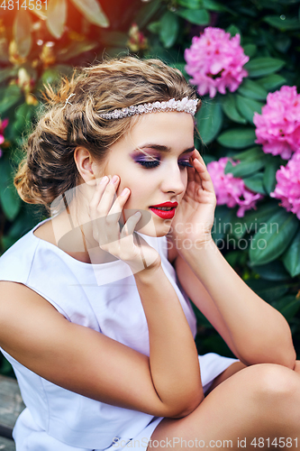 Image of girl in dress in rhododendron garden