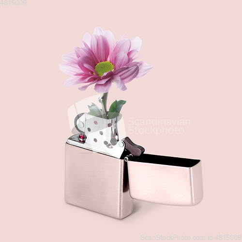 Image of Contemporary art collage, modern design. Summer mood. White lighter with blooming flower inside it on tender pink