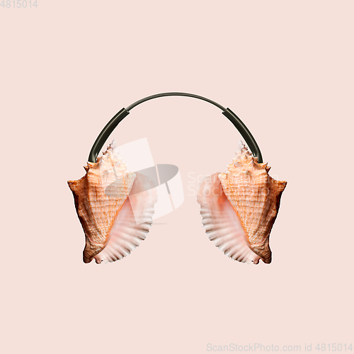 Image of Contemporary art collage, modern design. Summer mood. Headphones made of shells on pastel brown