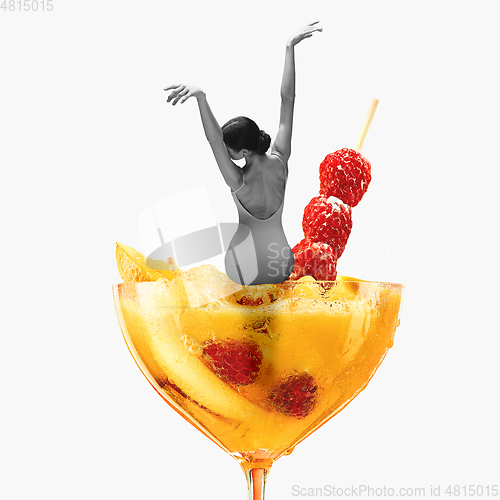 Image of Contemporary art collage, modern design. Summer mood. Tender ballerina sitting on giant cocktail glass with yellow berry drink