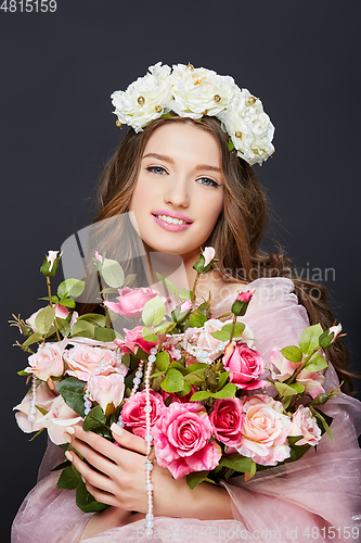 Image of beautiful girl with pink makeup and flowers