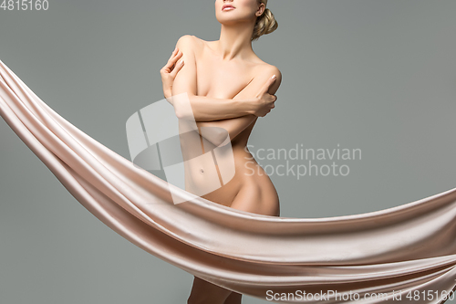 Image of beautiful naked woman with silk fabrics covering intimate zone