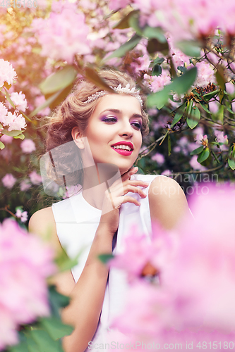 Image of girl in dress in rhododendron garden