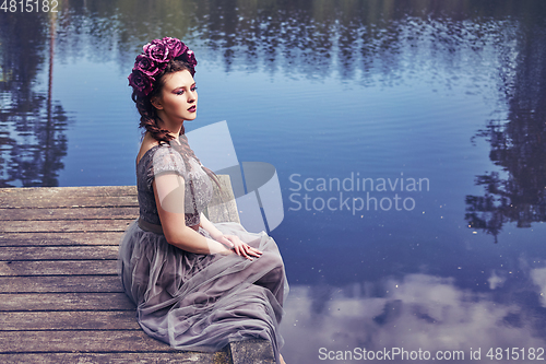 Image of girl in dress in rhododendron garden