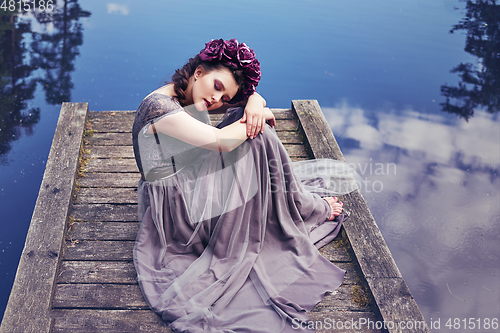 Image of girl in dress in rhododendron garden