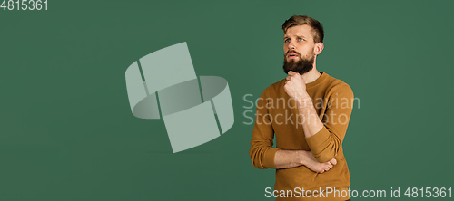 Image of Caucasian man\'s portrait isolated over green studio background with copyspace