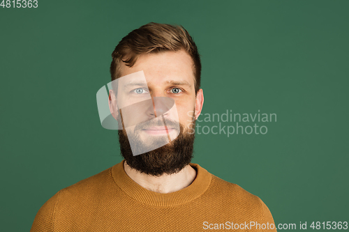 Image of Caucasian man\'s portrait isolated over green studio background with copyspace