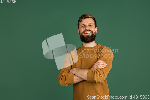 Image of Caucasian man\'s portrait isolated over green studio background with copyspace