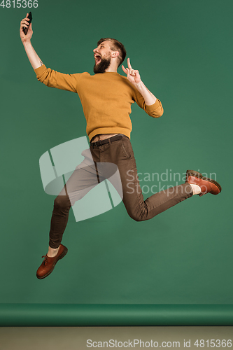 Image of Caucasian man\'s portrait isolated over green studio background with copyspace