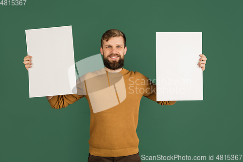 Image of Caucasian man\'s portrait isolated over green studio background with copyspace