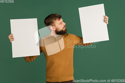 Image of Caucasian man\'s portrait isolated over green studio background with copyspace