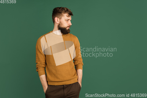 Image of Caucasian man\'s portrait isolated over green studio background with copyspace