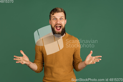 Image of Caucasian man\'s portrait isolated over green studio background with copyspace