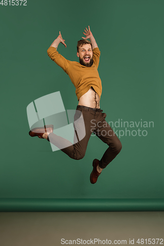 Image of Caucasian man\'s portrait isolated over green studio background with copyspace