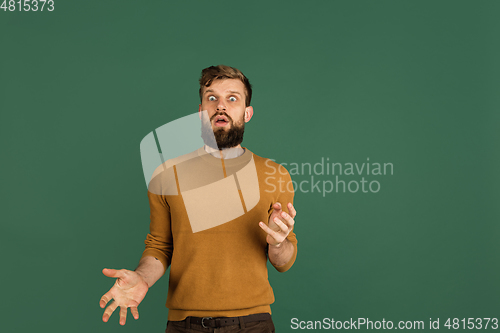 Image of Caucasian man\'s portrait isolated over green studio background with copyspace