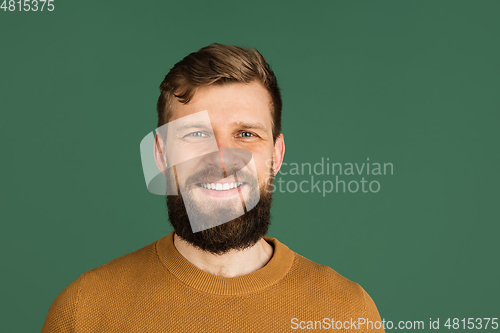 Image of Caucasian man\'s portrait isolated over green studio background with copyspace