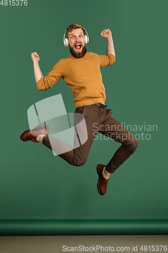 Image of Caucasian man\'s portrait isolated over green studio background with copyspace