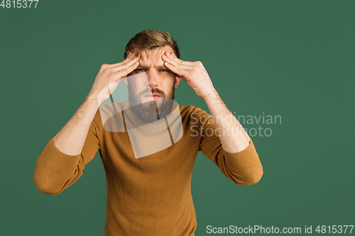 Image of Caucasian man\'s portrait isolated over green studio background with copyspace