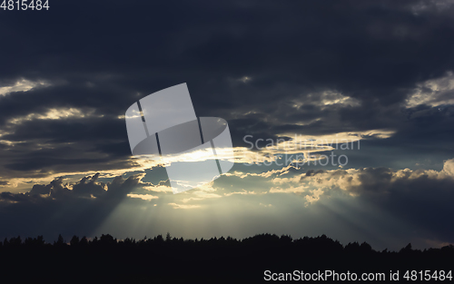 Image of Dark Dramatic Sky with Sunbeams Through Storm Clouds