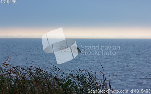 Image of Dark Stormy Seascape with Sunlight on the Horizon