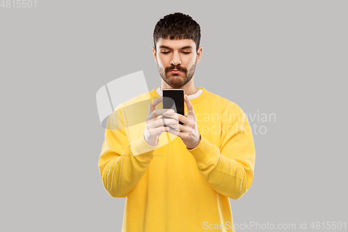Image of young man with smartphone