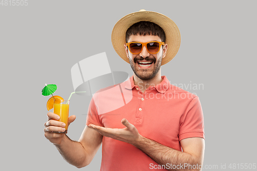 Image of happy man in straw hat with orange juice cocktail