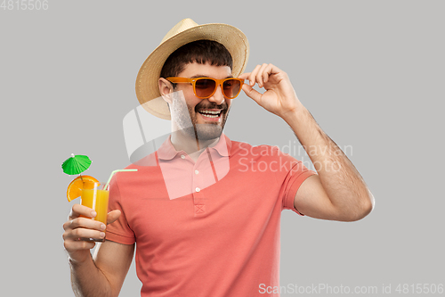 Image of happy man in straw hat with orange juice cocktail