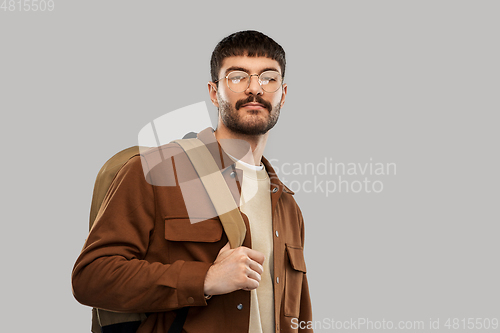 Image of young man in glasses with backpack