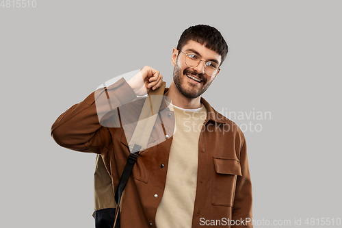 Image of smiling young man in glasses with backpack