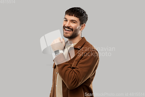 Image of smiling young man with smart watch