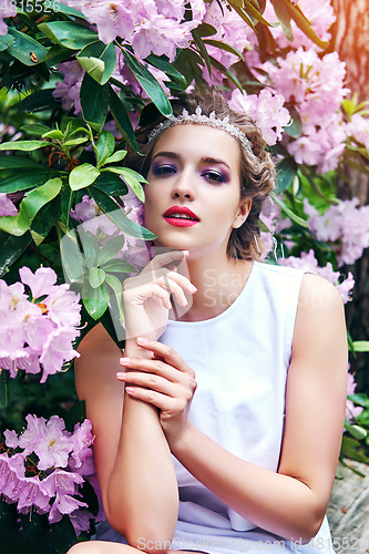 Image of girl in dress in rhododendron garden