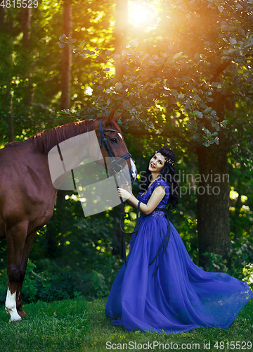 Image of beautiful girl in dress with horse