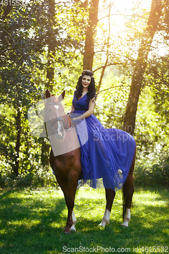 Image of beautiful girl in dress with horse