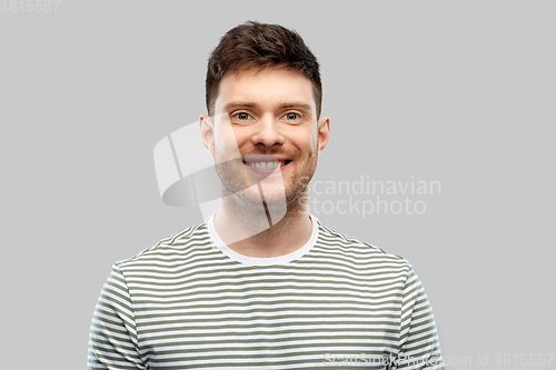 Image of smiling young man in striped t-shirt