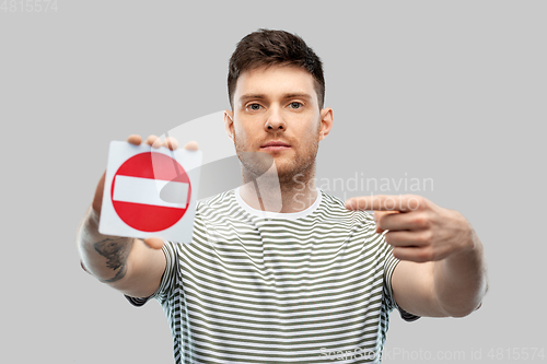 Image of young man showing stop sign