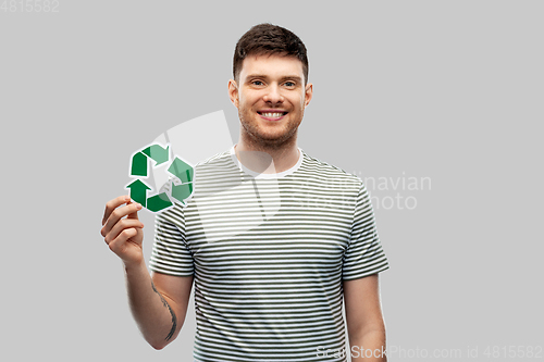 Image of smiling young man holding green recycling sign