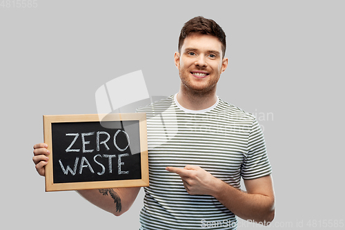 Image of smiling man holding chalkboard with zero waste