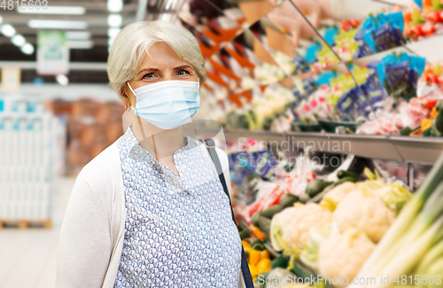 Image of senior woman in medical mask at supermarket