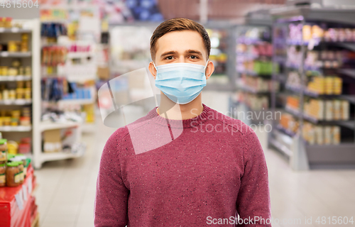 Image of young man in medical mask at supermarket