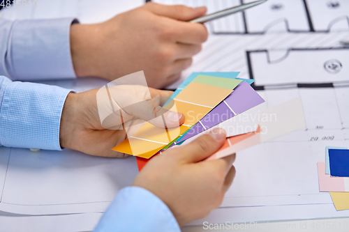 Image of close up of designers team working with blueprint