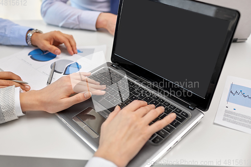 Image of close up of businesspeople with laptop at office