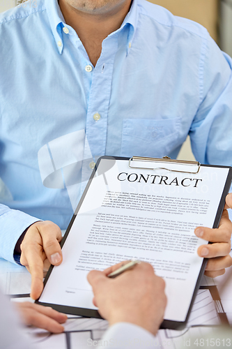 Image of customer signing contract document at office